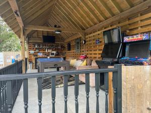 a screened in porch with a room with at Luxurious oasis relax 32c pool, jacuzzi games bar in Deal