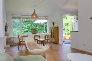a dining room and living room with a table and chairs at Previnaireweg 19 in Callantsoog