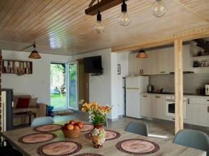 a kitchen and dining room with a table and chairs at Holiday House Valiug in Văliug