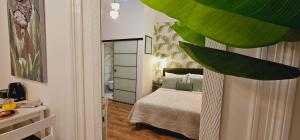 a small bedroom with a bed with green pillows at Room Lui, sa besplatnim parkingom in Rijeka