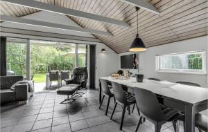 a kitchen and dining room with a table and chairs at Cozy Home In Hadsund With Sauna in Helberskov
