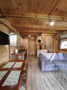 a living room with a couch and a table at Dom Nad Stawem Krawno in Piecki