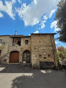 a stone building with a door and a garage at Private 2 bedrooms home in Saturnia centre in Saturnia