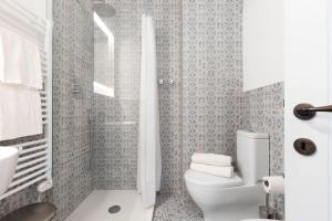 a white bathroom with a toilet and a shower at Casa Belvedere-Palazzo Riccardi in Rivalto +21 photos