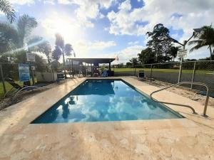 a large swimming pool with a gazebo at Hospederia Villa Alegre Estudio 7 in Cabo Rojo