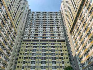 a tall apartment building with many windows at Best Homey and Nice Studio at Royal Sentul Park Apartment By Travelio in Bogor