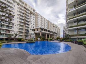 a large swimming pool in front of some buildings at Best Choice Studio Room Apartment at Gateway Pasteur By Travelio in Bandung