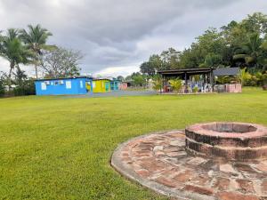 a fire pit in the middle of a grass field at Hospederia Villa Alegre Estudio 7 in Cabo Rojo +5 photos