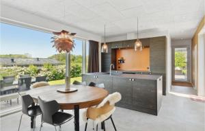 a kitchen and dining room with a table and chairs at 3 Bedroom Cozy Home In Børkop in Børkop