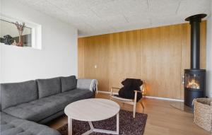 a living room with a couch and a fireplace at 3 Bedroom Cozy Home In Børkop in Børkop
