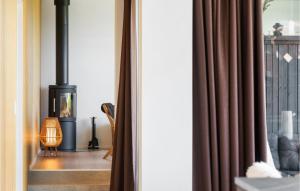 a room with a fireplace and a window at 3 Bedroom Cozy Home In Børkop in Børkop +12 photos