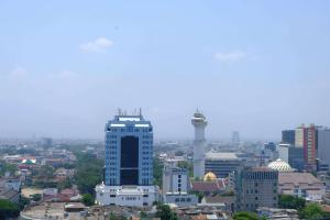 a view of a city with a tall building at Modern Look 3BR at Apartment Braga City Walk By Travelio in Bandung