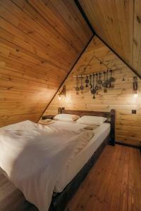 a large bed in a room with a wooden wall at Sapanca Kırsal Silence in Sapanca +20 photos