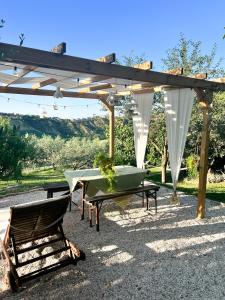 a table and a chair under a pergola at Relaxing farmhouse in San Marino +87 photos
