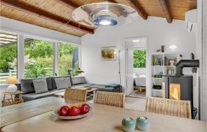 a living room with a table with fruit on it at Holiday Home Vejby With Fireplace I in Vejby