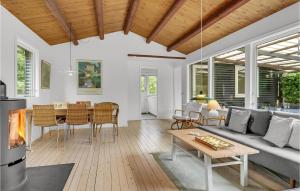 a living room with a couch and a table at Holiday Home Vejby With Fireplace I in Vejby