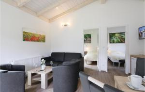 a living room with a couch and a table at Ferienhausdorf Thale in Thale