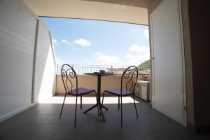 a table and two chairs on a balcony at Soraya Rooms Tropea in Tropea