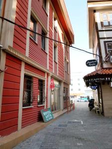 a red building with a sign on the side of it at Asya Hotel in Konya