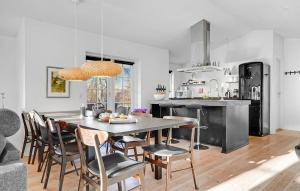 a kitchen and dining room with a table and chairs at 3 Bedroom Amazing Home In Glesborg in Glesborg