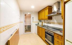 a kitchen with wooden cabinets and a stove top oven at 3 Bedroom Stunning Apartment In Calpe in Calpe