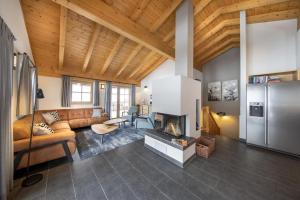 un salon avec un canapé et une cheminée dans l'établissement Schöneben Chalet Hohe Schwalbe, à Wald im Pinzgau