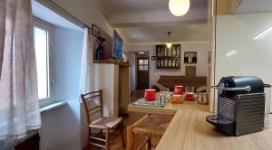 a small kitchen and dining room with a table with aasy at Cinque terre - Le Grazie On the Waterfront in Portovenere