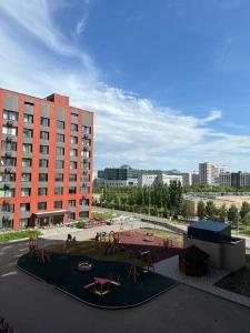 a playground in front of a large building at Cozy Urban Retreat in Prigorodnyy +37 photos