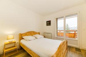 Posteľ alebo postele v izbe v ubytovaní Homency - Résidence de l'Alpe 19