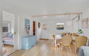 a kitchen and dining room with a table and chairs at Stunning Home In Nykøbing Sj With Wifi in Nykøbing Sjælland