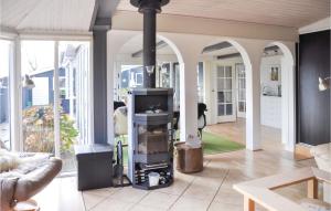 a living room with a wood stove in the middle at Five-Bedroom Holiday Home In Otterup in Otterup
