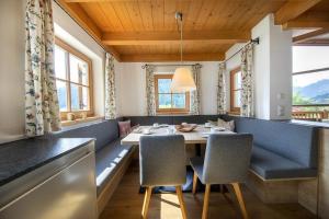 a dining room with a table and chairs at Schöneben Chalet Holzblick in Wald im Pinzgau