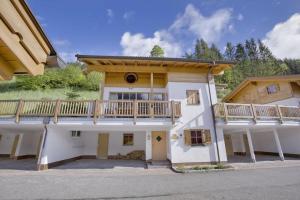 a large house with a balcony on top of it at Schöneben Chalet Holzblick in Wald im Pinzgau