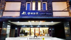 高雄德瑞旅店Direct Hotel的一栋建筑前坐着一只狗