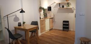 a kitchen with a desk and a table and chairs at Gretchens in Cochem