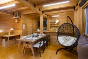 a dining room with a table and a swing at BRICK HOUSEⅡ in Furano
