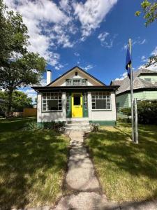 a house with a yellow door and a yellow door at Upper Yellowstone Suite in Livingston