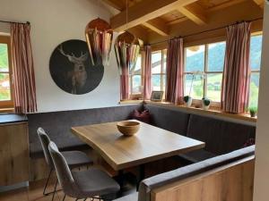 a dining room with a wooden table and chairs at Schöneben Chalet MilKa in Wald im Pinzgau