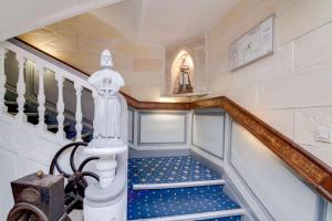 a staircase in a home with blue and white stairs at Brit Hotel Comtes De Champagne - Troyes Centre Historique in Troyes