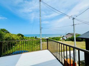 a balcony with a view of the ocean at Kamizawa Villa - BBQ x オーシャンビュー in Kumiage