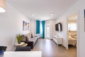 a living room with a couch and a table at Rentalmar Murillo Plus in Salou