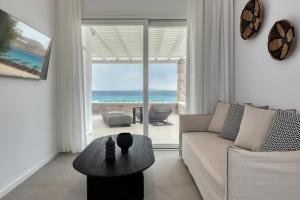 a living room with a couch and a table at Elia Mykonos Resort in Elia Beach