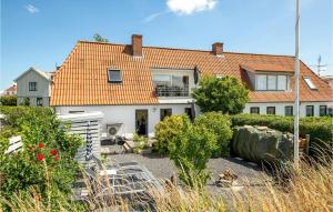 a white house with an orange roof at Two-Bedroom Holiday Home In Haderslev in Haderslev