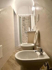 a white bathroom with a sink and a toilet at A casa di nonna in Fondi
