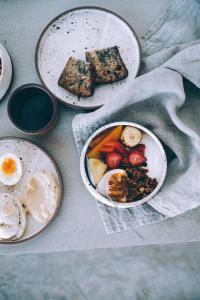 three plates of food on a table with eggs and bread at Mint Santa Teresa - Adults only in Santa Teresa Beach