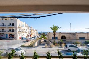 a view of a street with cars parked in a parking lot at Mellieha, Charming 2 Bedroom Apartment Santa Maria Heights Mellieha in Mellieħa