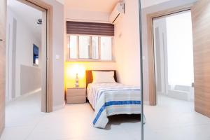 a bedroom with a bed and a glass door at Mellieha, Charming 2 Bedroom Apartment Santa Maria Heights Mellieha in Mellieħa