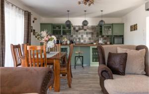 a kitchen with green cabinets and a table and chairs at Lovely Home In Medulin With Wifi in Medulin