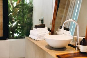 a bathroom with a sink and a bowl on a counter at Mint Santa Teresa - Adults only in Santa Teresa Beach