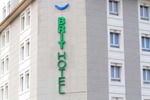 a hotel sign on the side of a building at Brit Hotel Calais in Calais